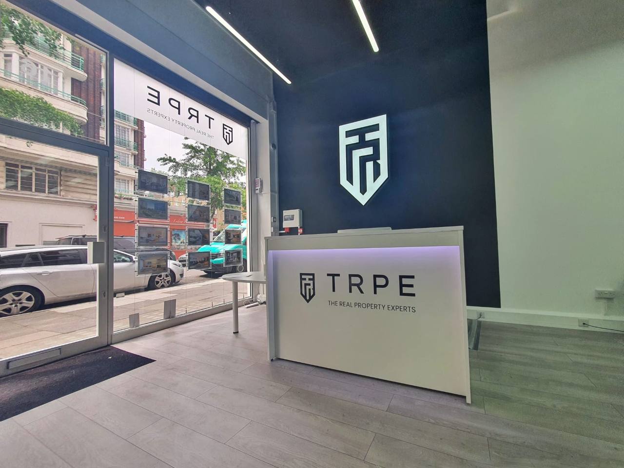 TRPE London office interior — navy wall, TRPE shield, reception desk, 2021