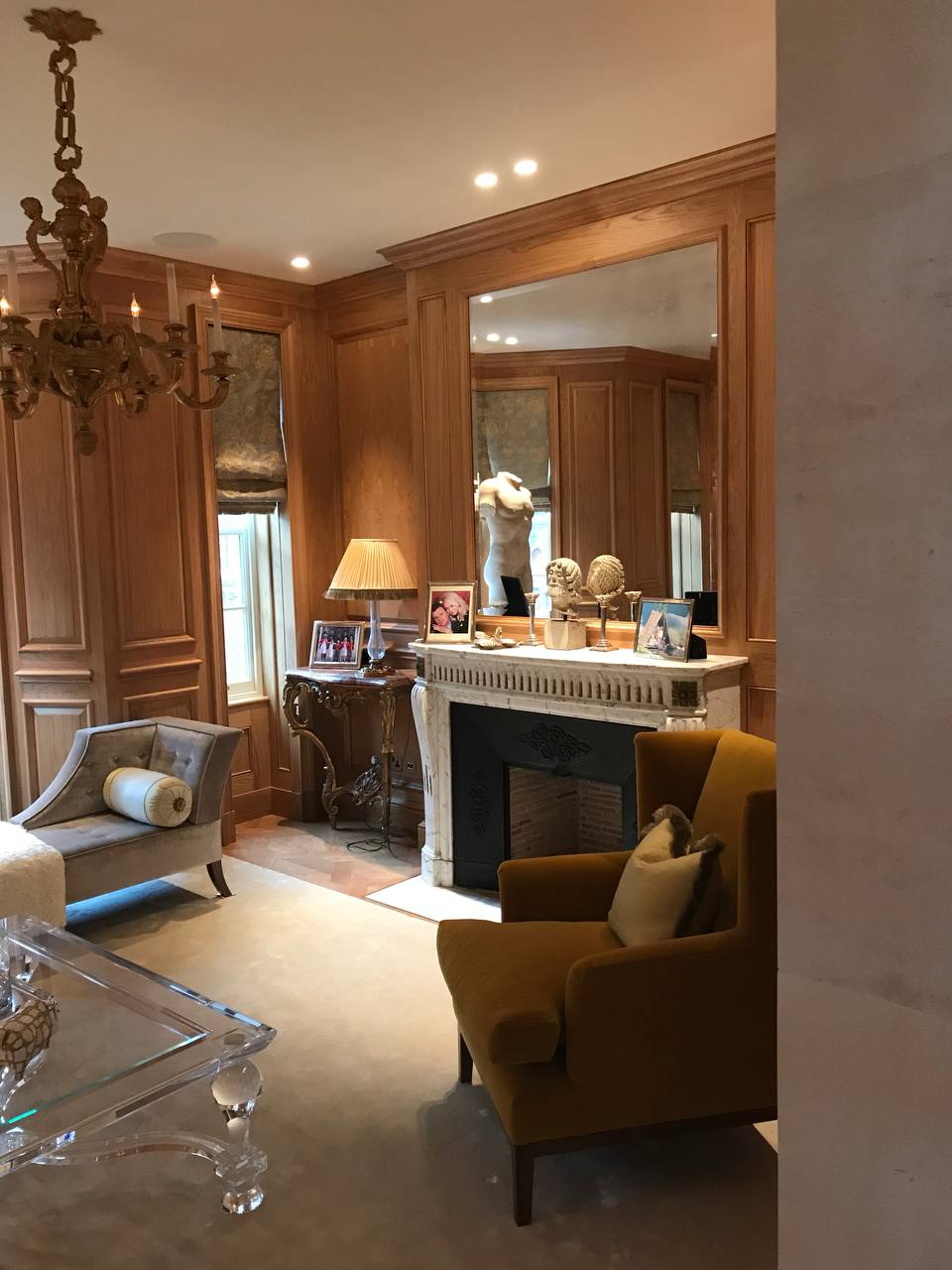 Drawing room — marble fireplace, mustard wingback chairs, oak panelling