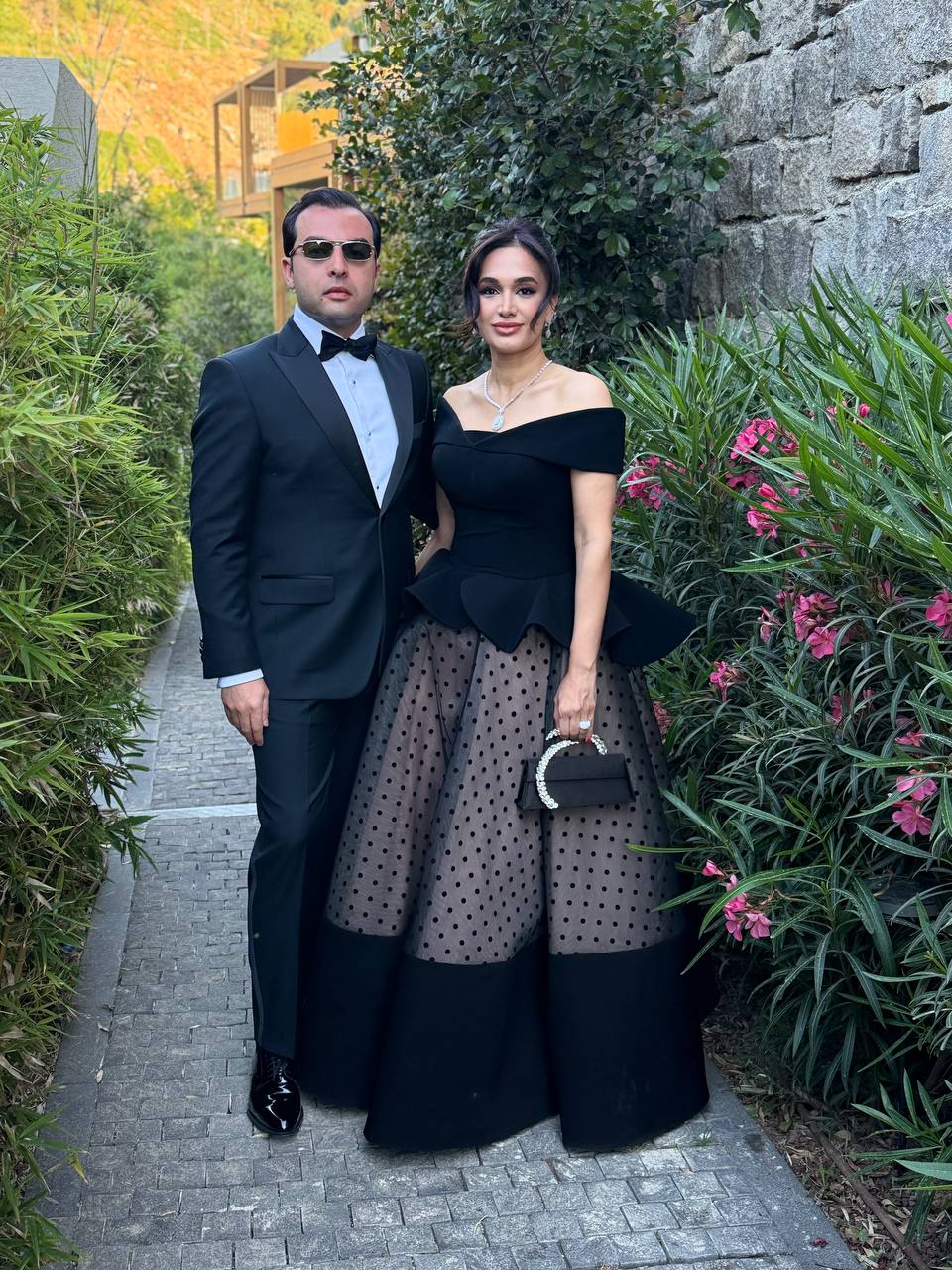 Saied Nazemi and wife at a friend's wedding, black tie, garden setting, Bodrum 2025